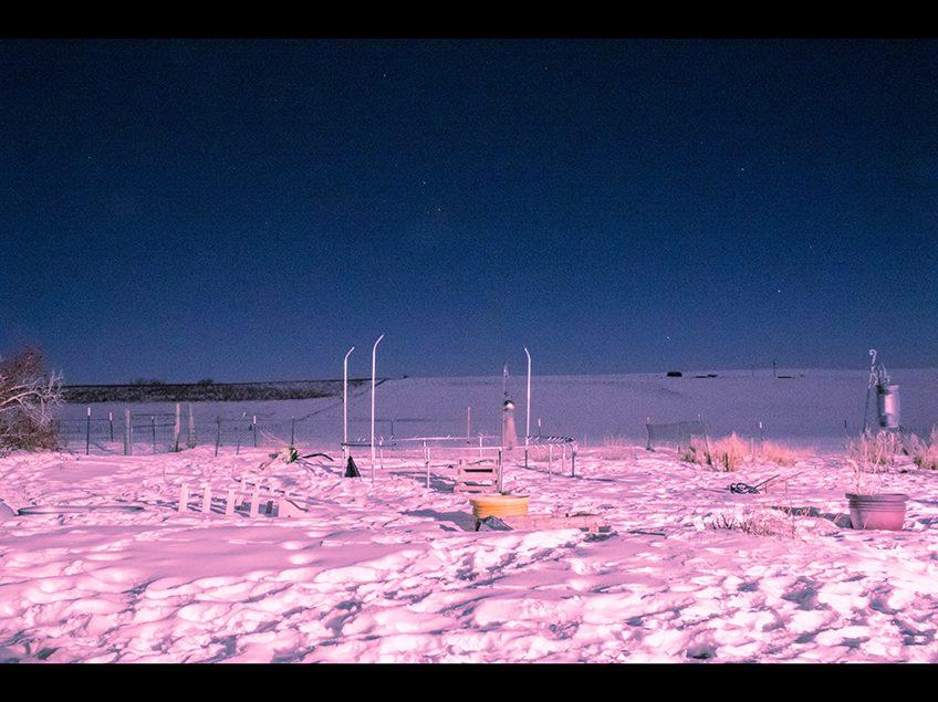 Color night landscape with a horizon. Snow in the foreground tinted pink.
