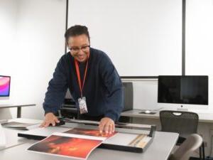 A student crops a print in the Photography Lab.